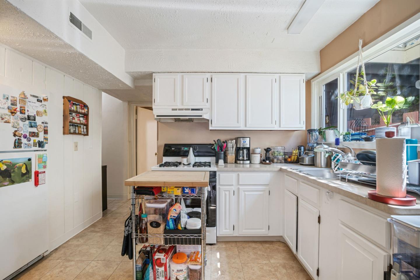 1128 Oddstad Boulevard Pacifica, CA 94044 - Photo 28 of 35 a kitchen with a white cabinets and window