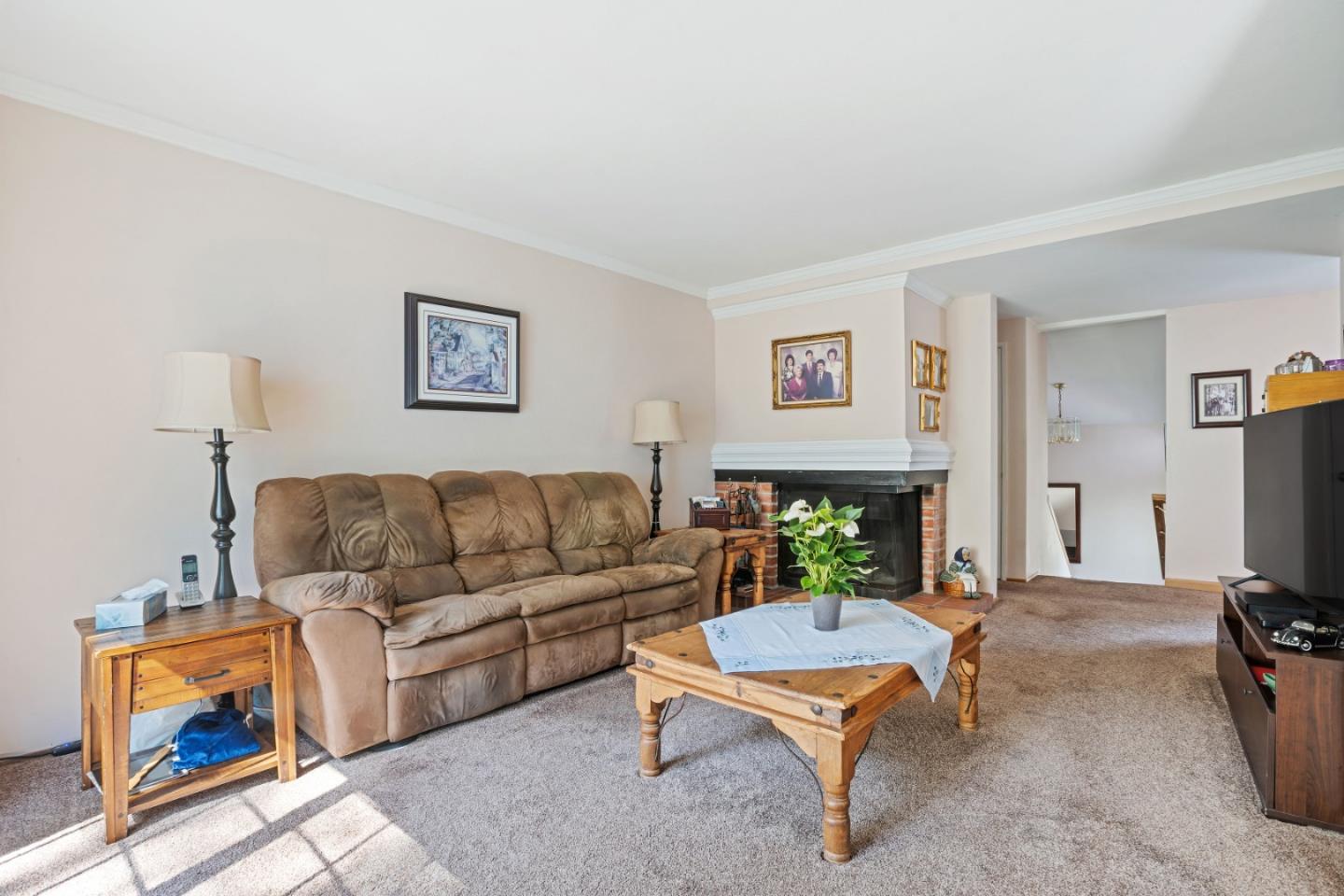 1128 Oddstad Boulevard Pacifica, CA 94044 - Photo 3 of 35 a living room with furniture a flat screen tv and a fireplace