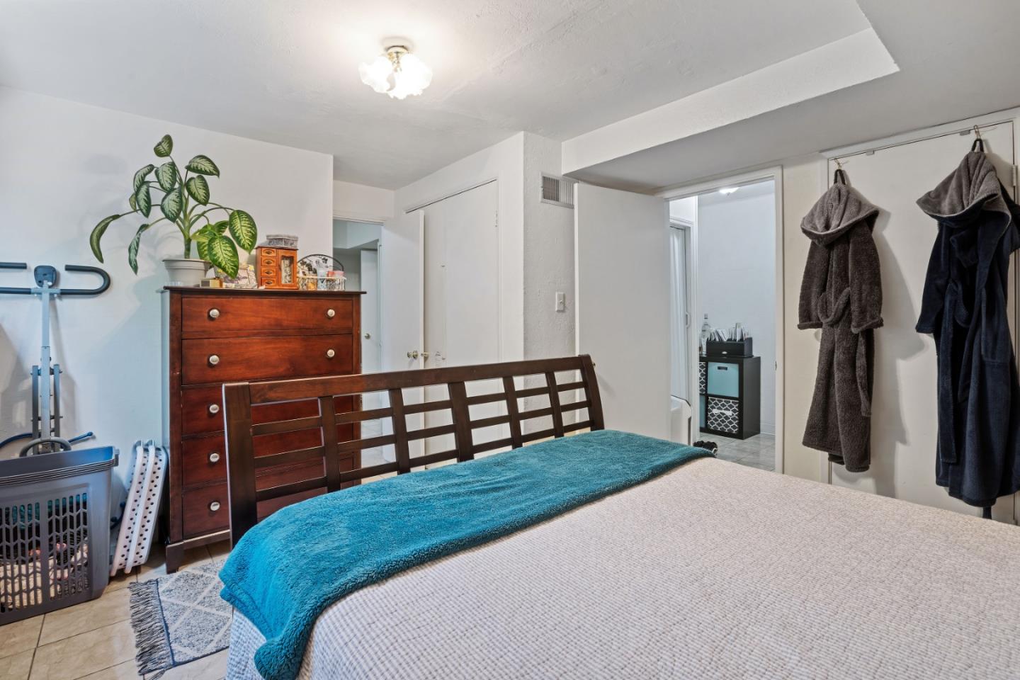 1128 Oddstad Boulevard Pacifica, CA 94044 - Photo 32 of 35 a bedroom with a bed and a dresser in it