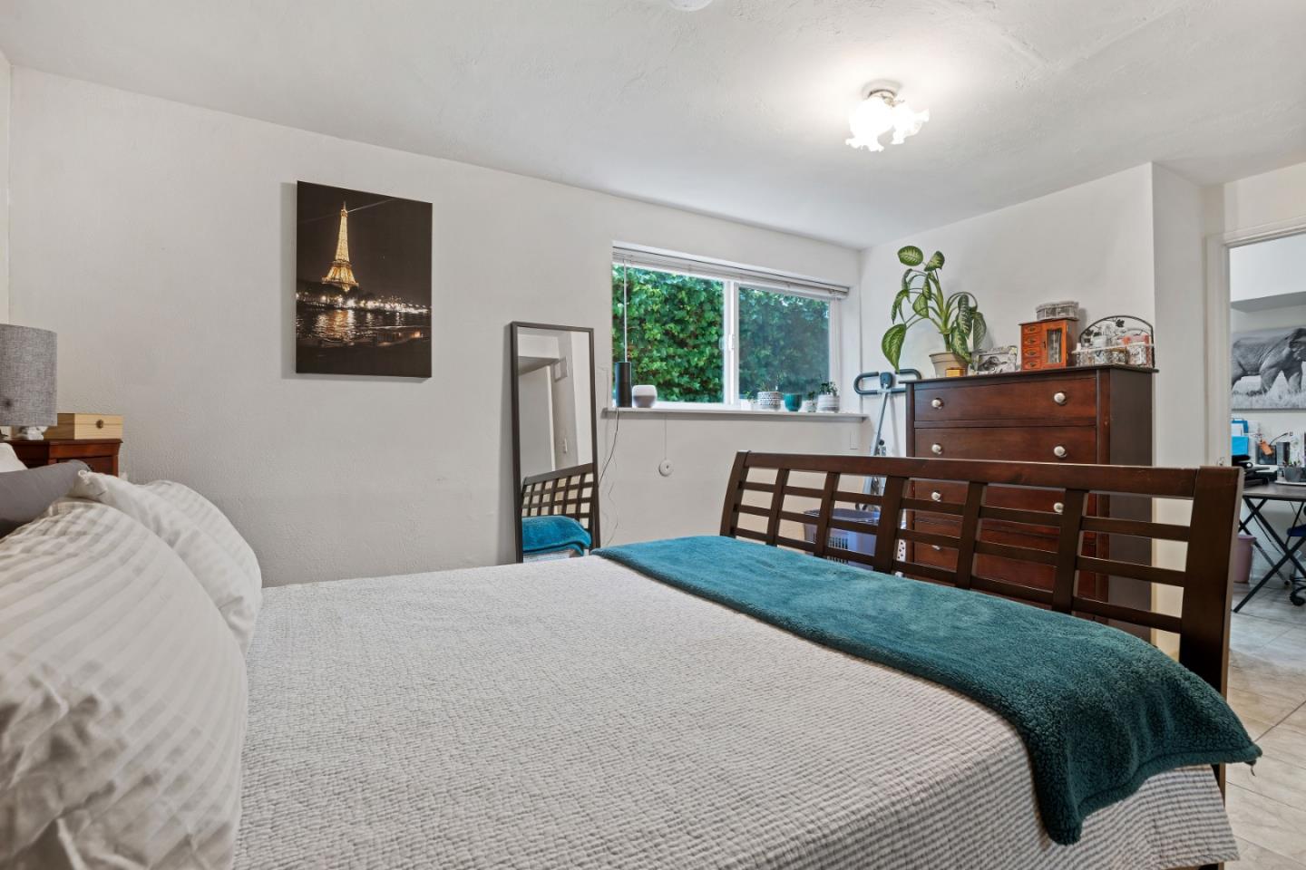 1128 Oddstad Boulevard Pacifica, CA 94044 - Photo 33 of 35 a bedroom with a bed a dresser and a large mirror