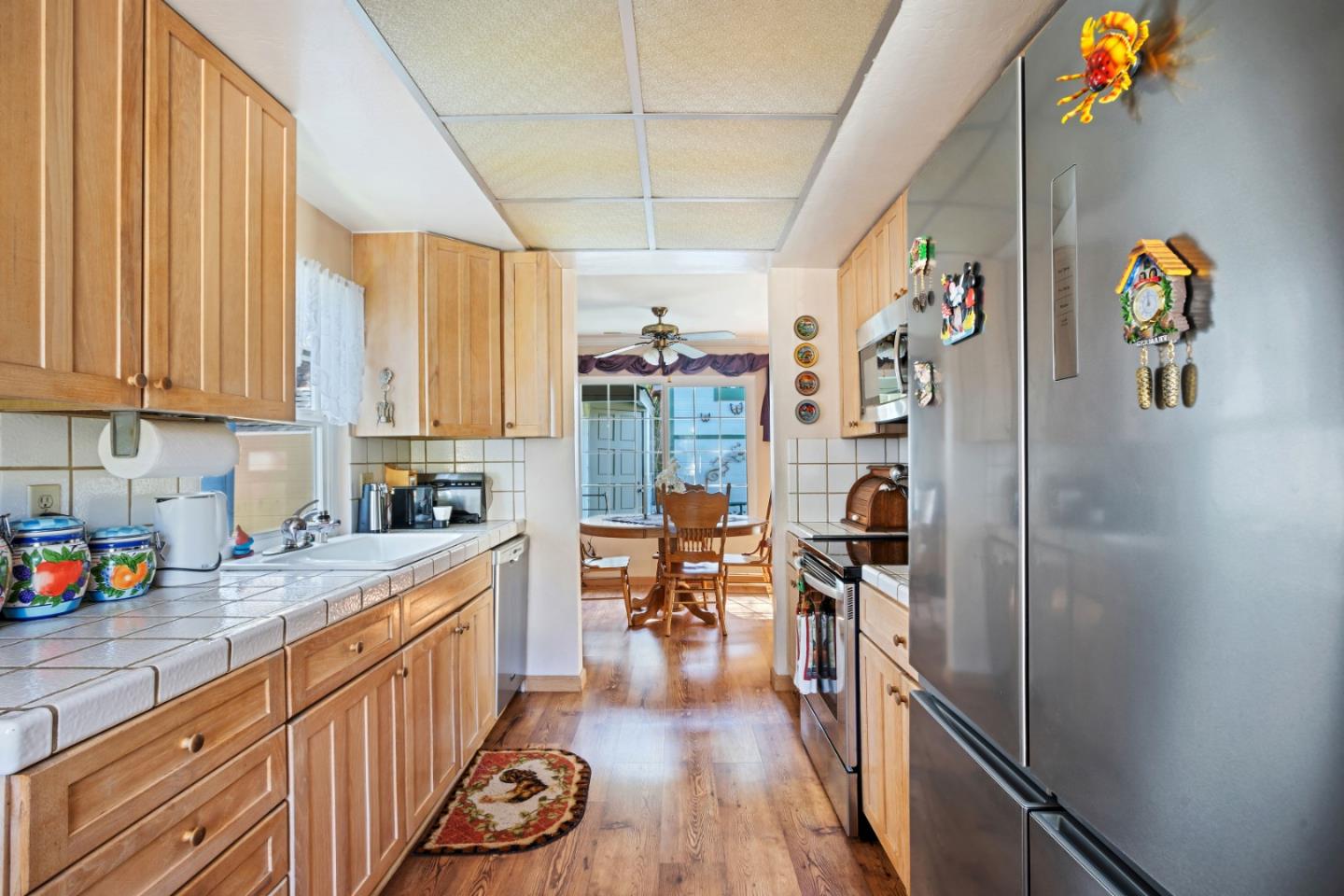1128 Oddstad Boulevard Pacifica, CA 94044 - Photo 8 of 35 a kitchen that has a lot of cabinets a sink and a stove in it
