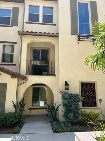 a front view of a house with plants