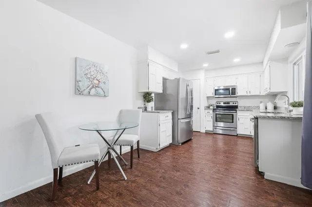 a view of kitchen with refrigerator microwave and wooden floor