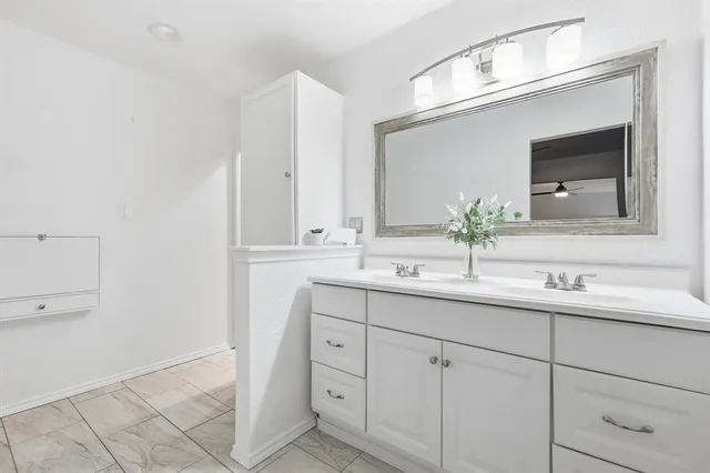 a bathroom with a double vanity sink and mirror