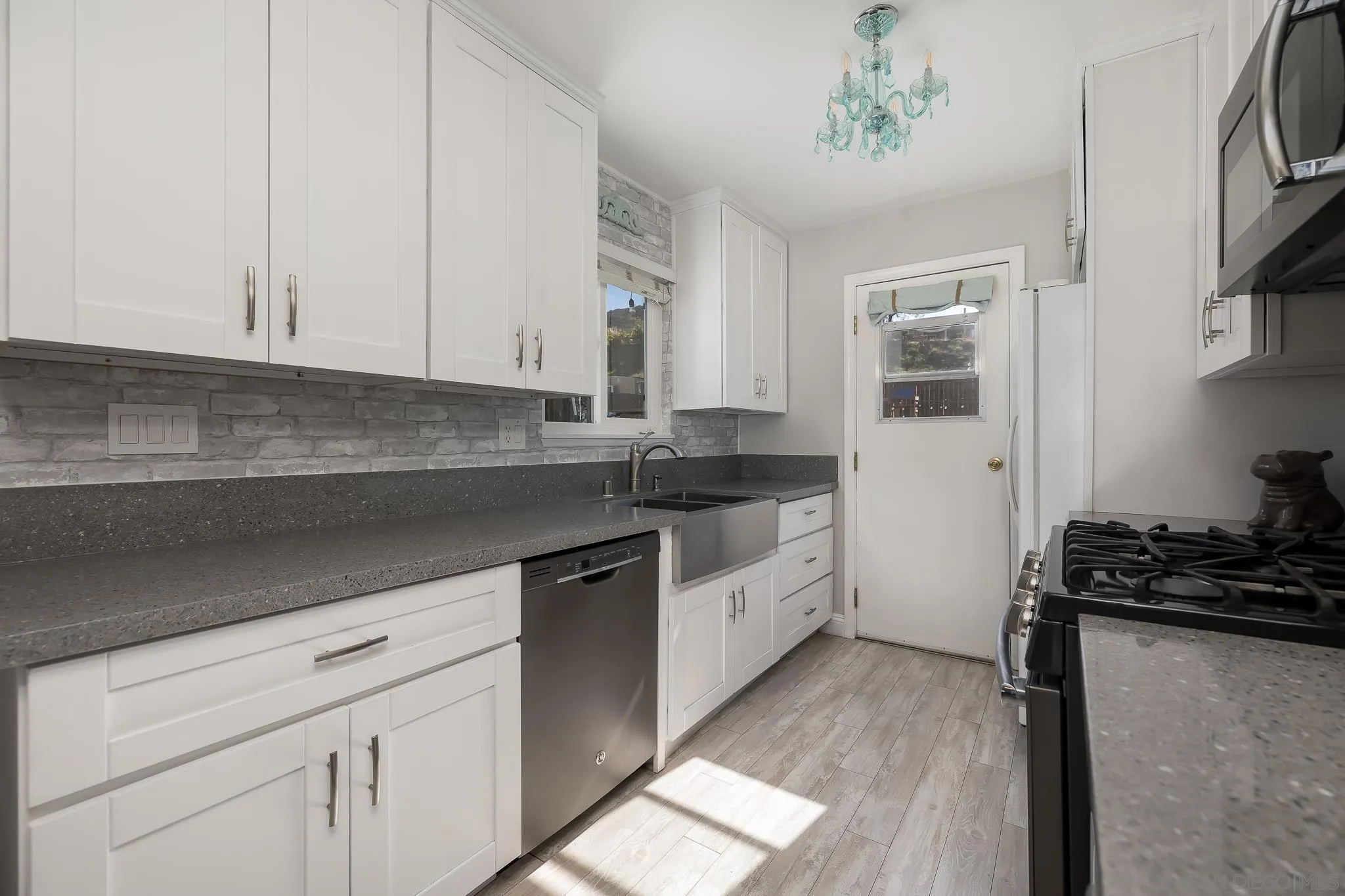 9126 Heatherdale Street Santee, CA 92071 - Photo 11 of 33 a kitchen with granite countertop a sink a stove and cabinets