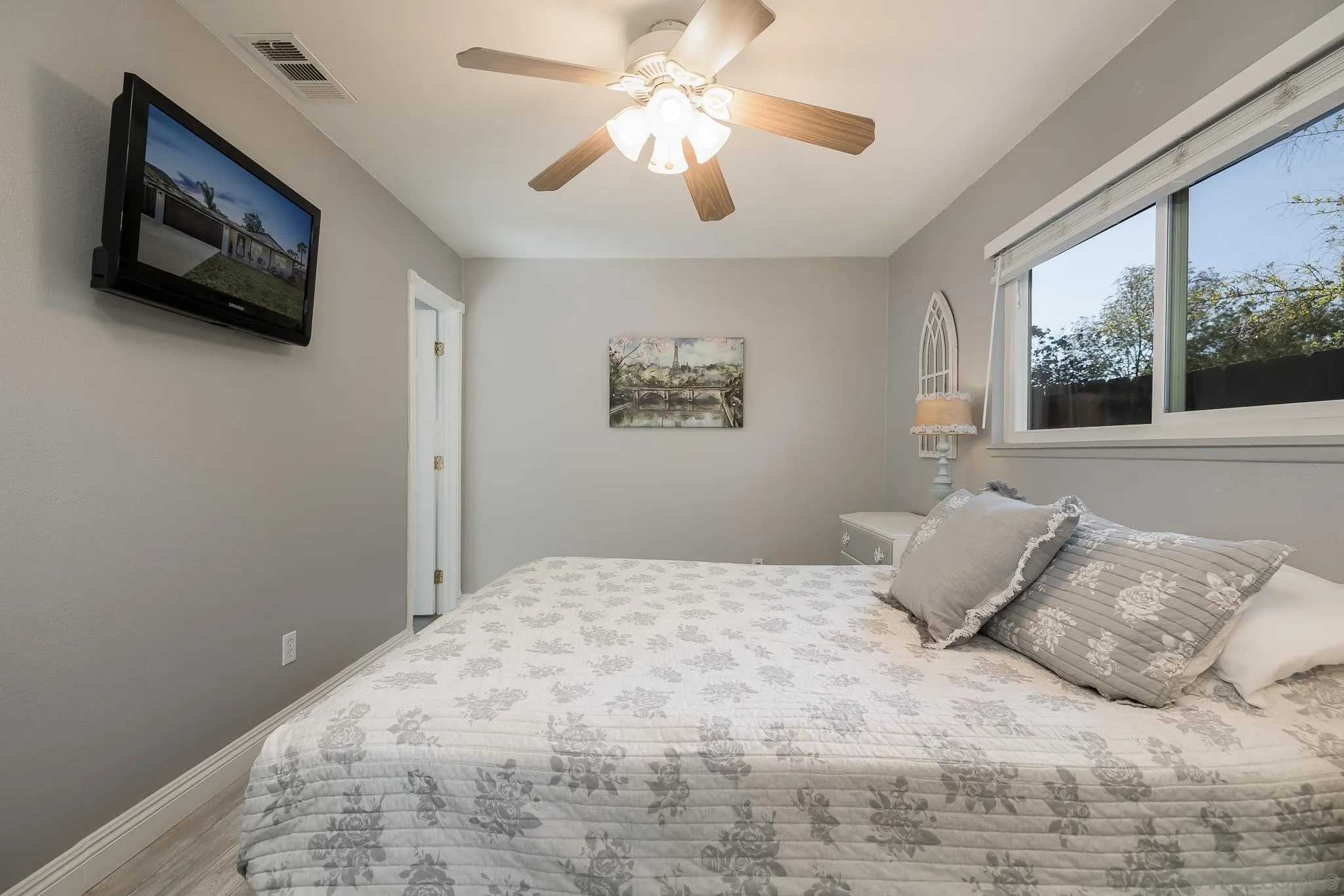 9126 Heatherdale Street Santee, CA 92071 - Photo 13 of 33 a bedroom with a large bed and a flat screen tv