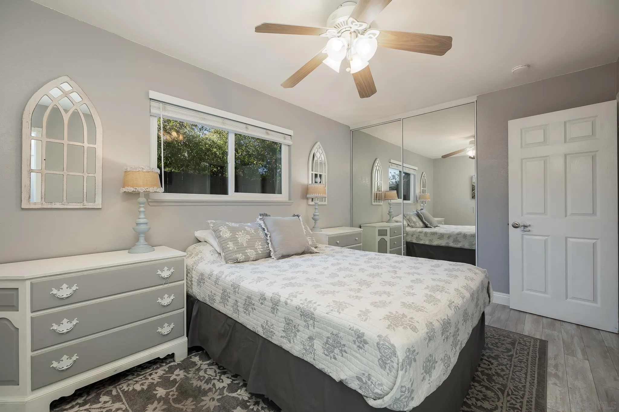 9126 Heatherdale Street Santee, CA 92071 - Photo 14 of 33 a bed room with a bed and a chandelier