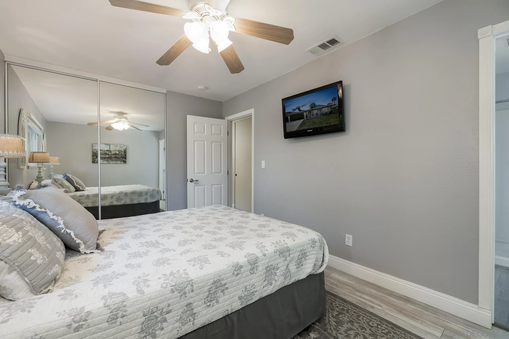 9126 Heatherdale Street Santee, CA 92071 - Photo 15 of 33 a bedroom with a bed and a chandelier