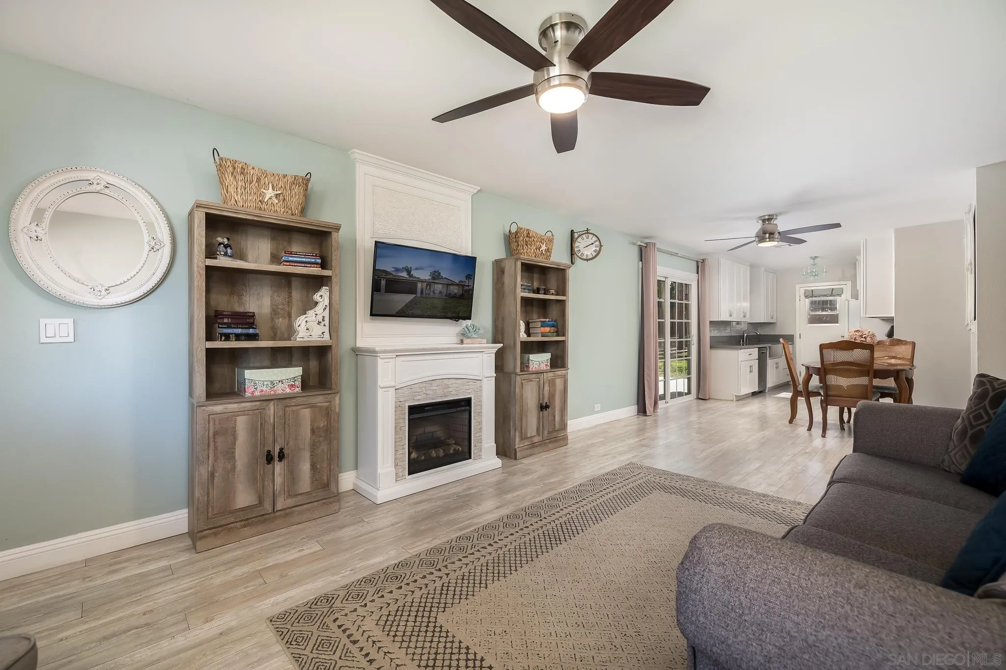 9126 Heatherdale Street Santee, CA 92071 - Photo 6 of 33 a living room with furniture a fireplace and a flat screen tv