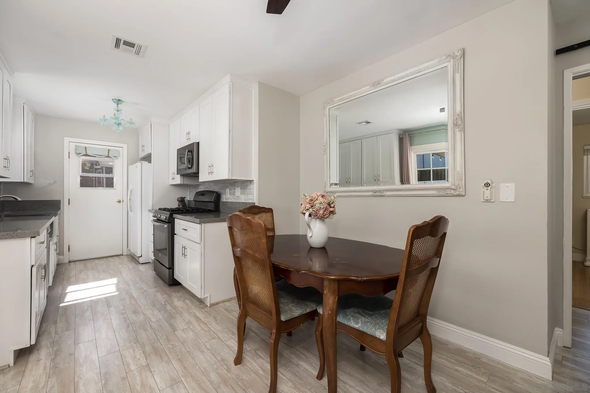 9126 Heatherdale Street Santee, CA 92071 - Photo 9 of 33 a view of a dining room with furniture and wooden floor