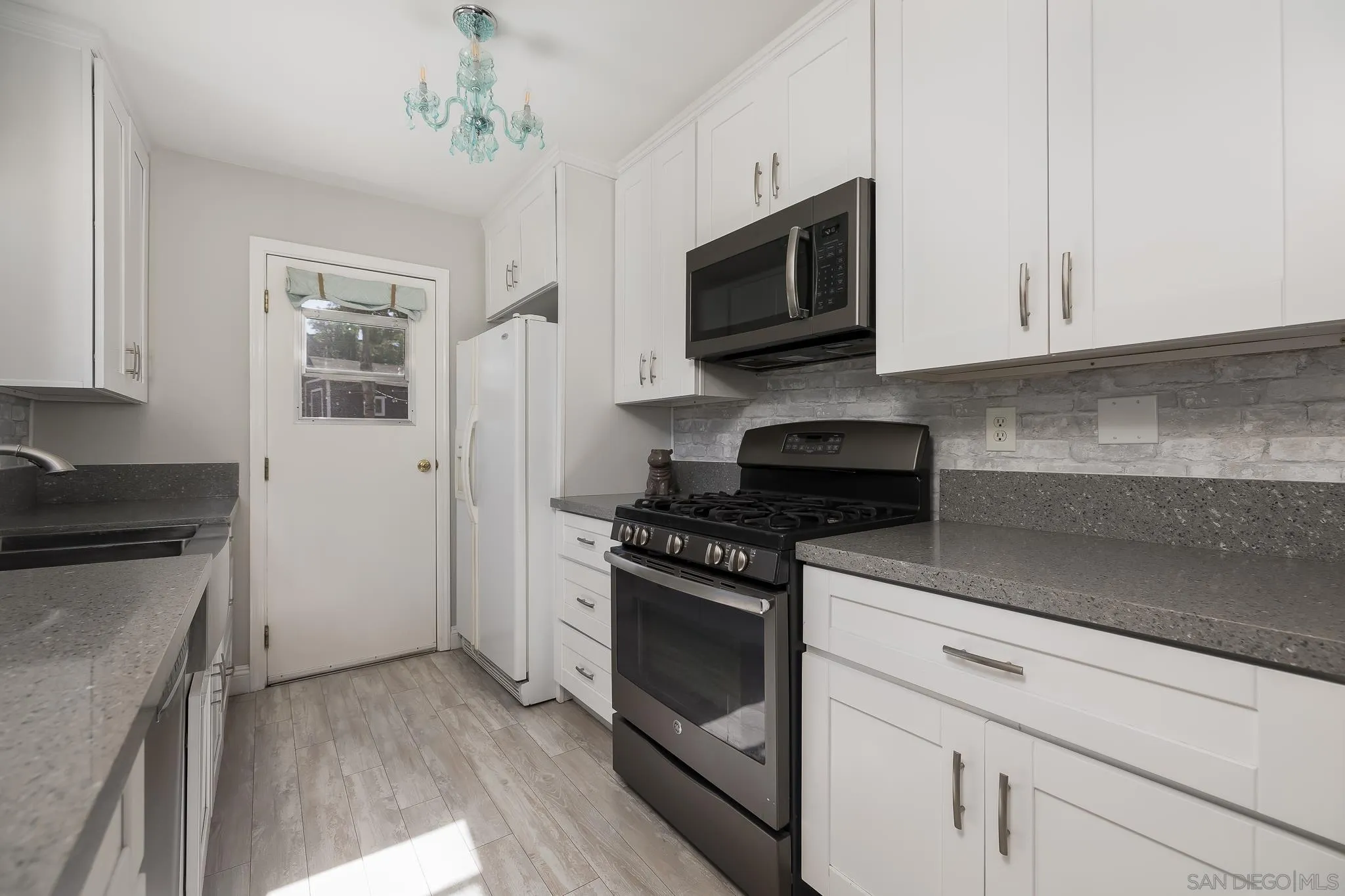 9126 Heatherdale Street Santee, CA 92071 - Photo 10 of 33 a kitchen with stainless steel appliances granite countertop white cabinets granite counter tops and a stove