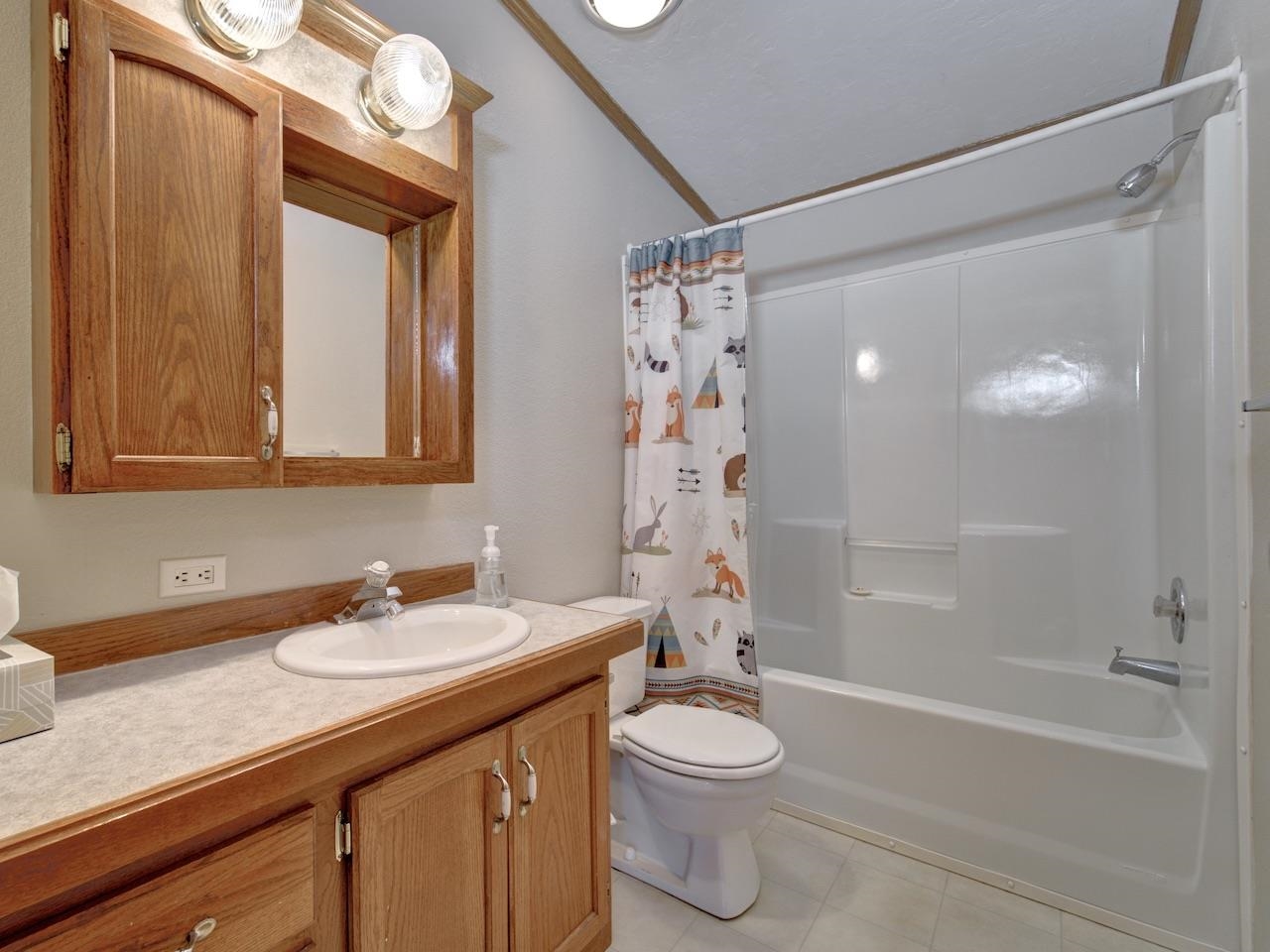 2206 I Road Grand Junction, CO 81505 - Photo 15 of 28 a bathroom with a granite countertop sink a toilet and shower