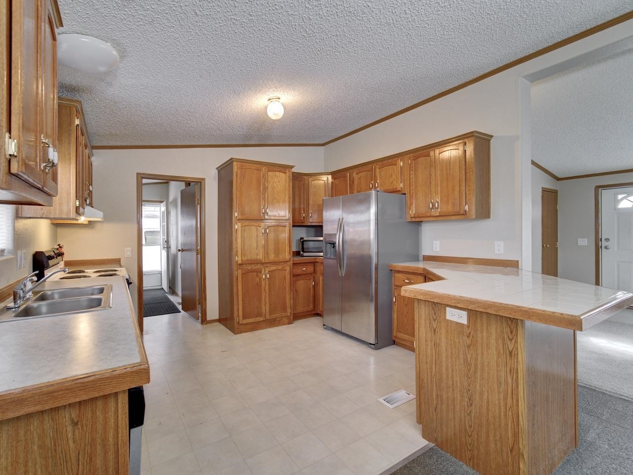 2206 I Road Grand Junction, CO 81505 - Photo 4 of 28 a kitchen with refrigerator and car
