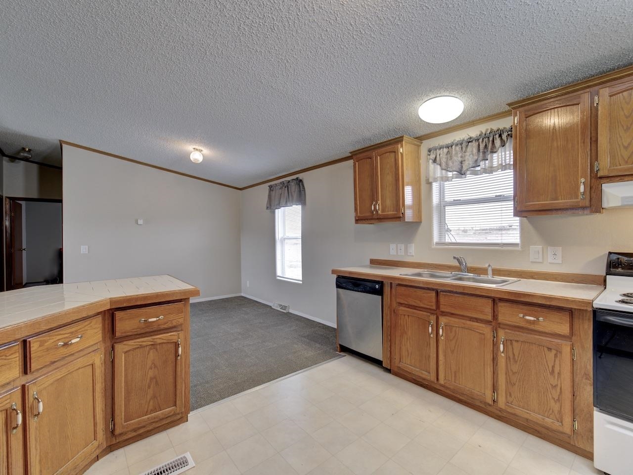 2206 I Road Grand Junction, CO 81505 - Photo 6 of 28 a kitchen with granite countertop cabinets stainless steel appliances a sink and a window