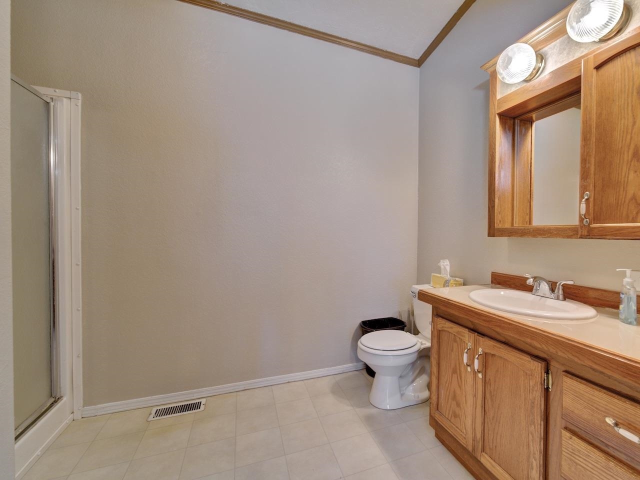 2206 I Road Grand Junction, CO 81505 - Photo 10 of 28 a bathroom with a toilet sink and mirror