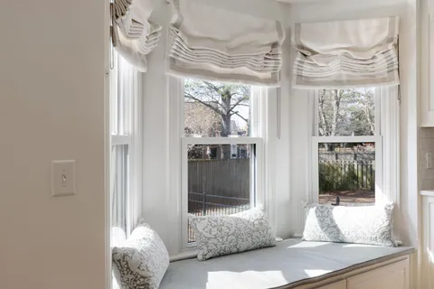 a room with wooden floor and large windows