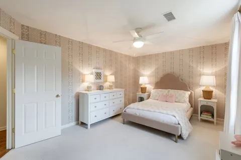 a bedroom with a bed and a lamp