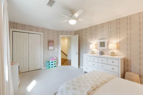 a bed room with a bed mirror and a window