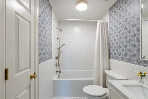 a bathroom with a toilet and a bathtub