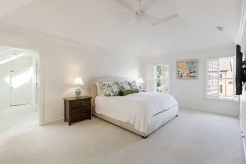 a spacious bedroom with a bed and window
