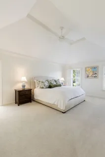a bedroom with a bed and a night stand