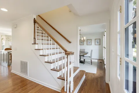 a view of entryway and hall with wooden floor