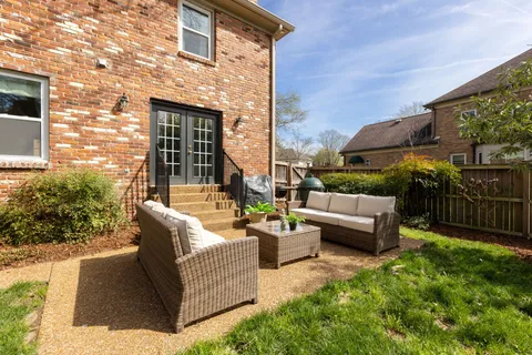 a view of a patio with couches and potted plants