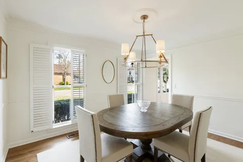 a view of a dining room with a table and chairs