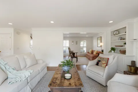 a living room with furniture a rug and a window