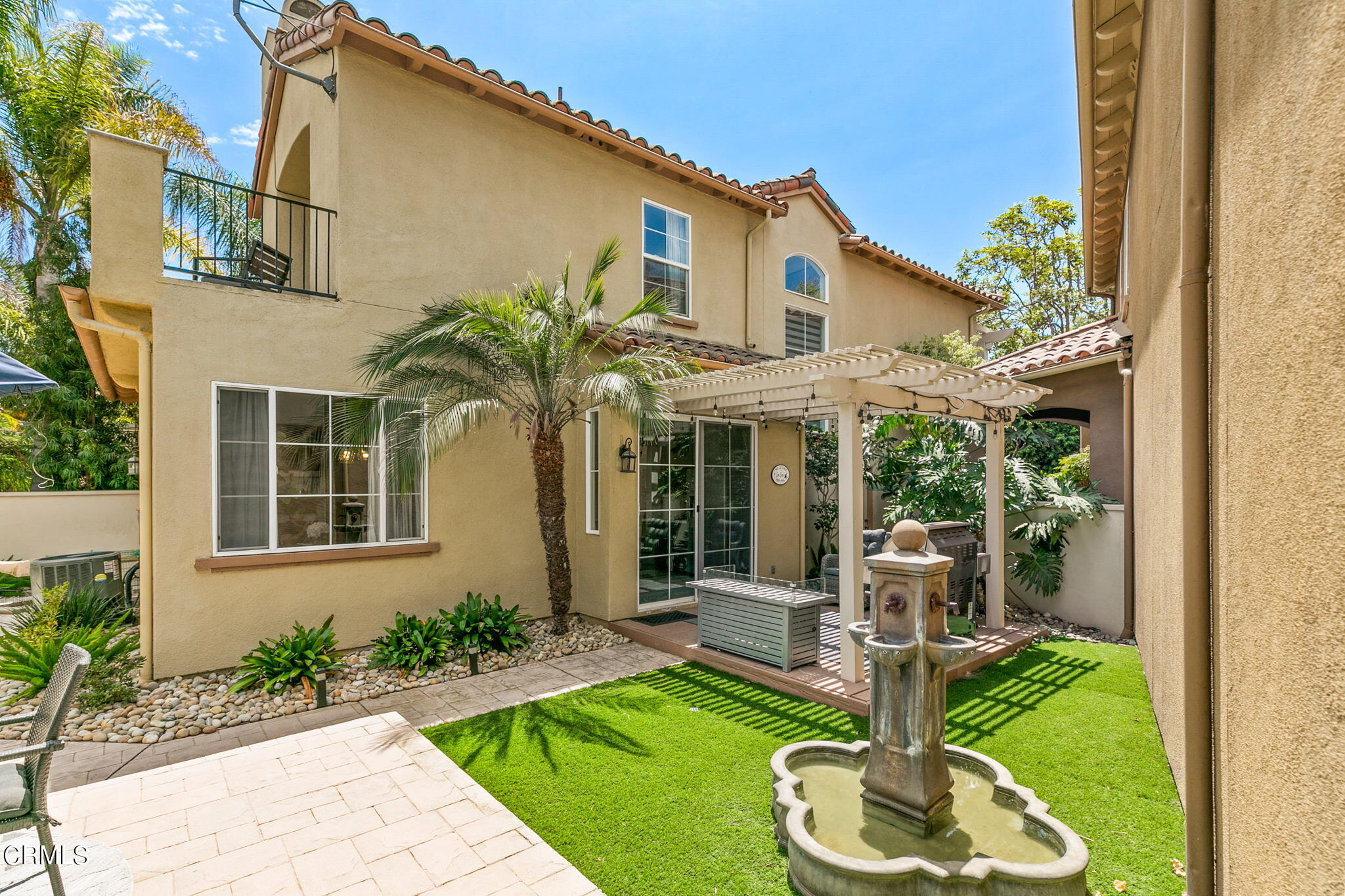 1132 Corte Riviera Camarillo, CA 93010 - Photo 18 of 20 a front view of a house with a yard table and chairs