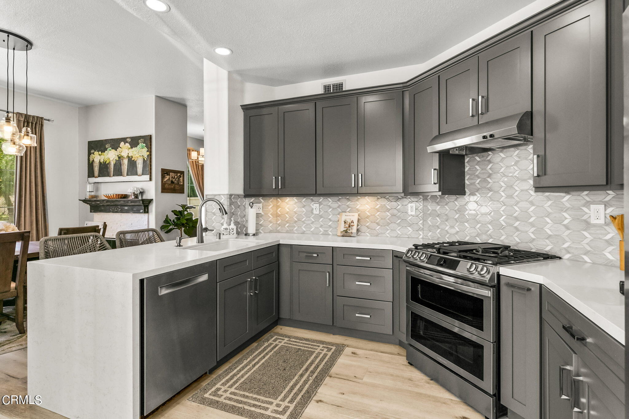 1132 Corte Riviera Camarillo, CA 93010 - Photo 6 of 20 a kitchen with kitchen island granite countertop a sink stove and cabinets