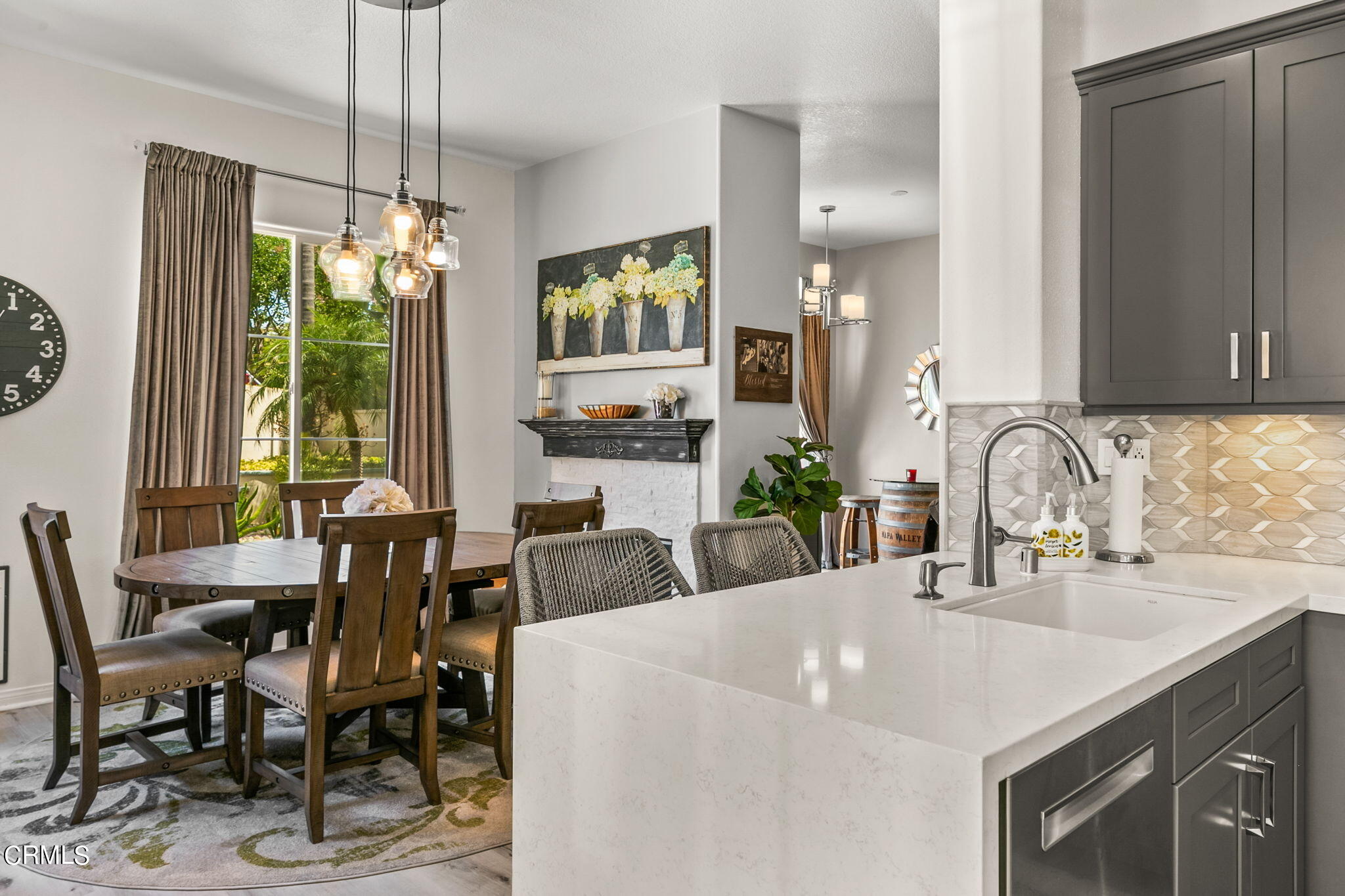 1132 Corte Riviera Camarillo, CA 93010 - Photo 7 of 20 a kitchen with a table chairs and white cabinets