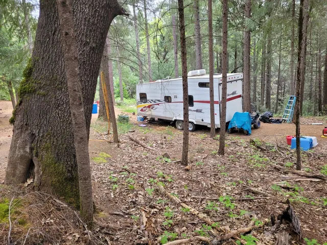 a backyard of a house with barbeque oven table and chairs