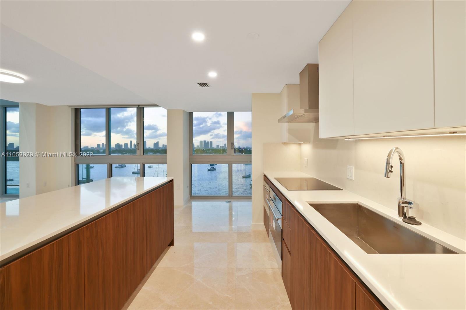 1504 Bay Road, Unit N0915 Miami Beach, FL 33139 - Photo 10 of 94 a large kitchen with a large window and a sink