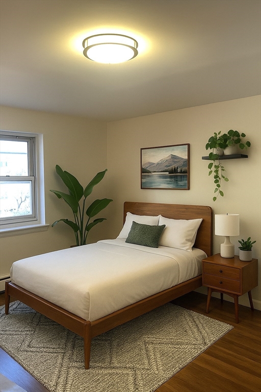 105 Chestnut Street, Unit 2 Brookline, MA 02445 - Photo 1 of 7 a bedroom with a bed and a chandelier