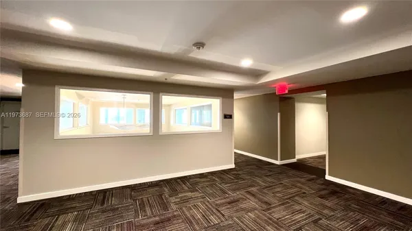 a front view of a residential apartment building with a yard