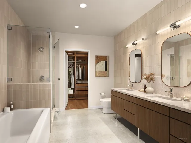 a en suite bathroom with double vanity sinks and a bathtub