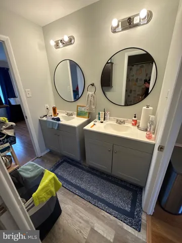 a bathroom with a toilet mirror and tub