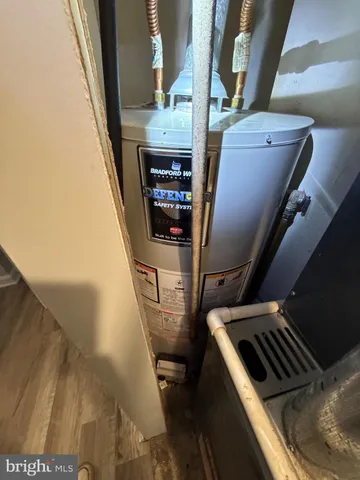 a view of a patio with table and chairs potted plants and a large tree
