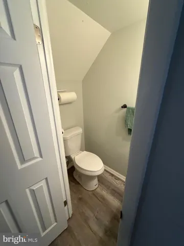 a white toilet sitting next to a sink and a mirror
