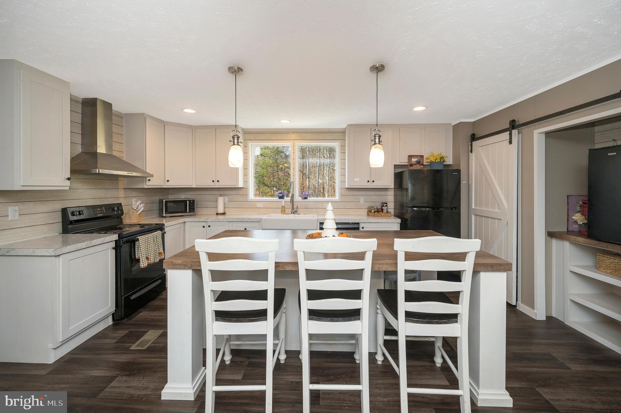 5120 Burr Hill Road Rhoadesville, VA 22542 - Photo 11 of 45 a kitchen with a stove a sink and a refrigerator