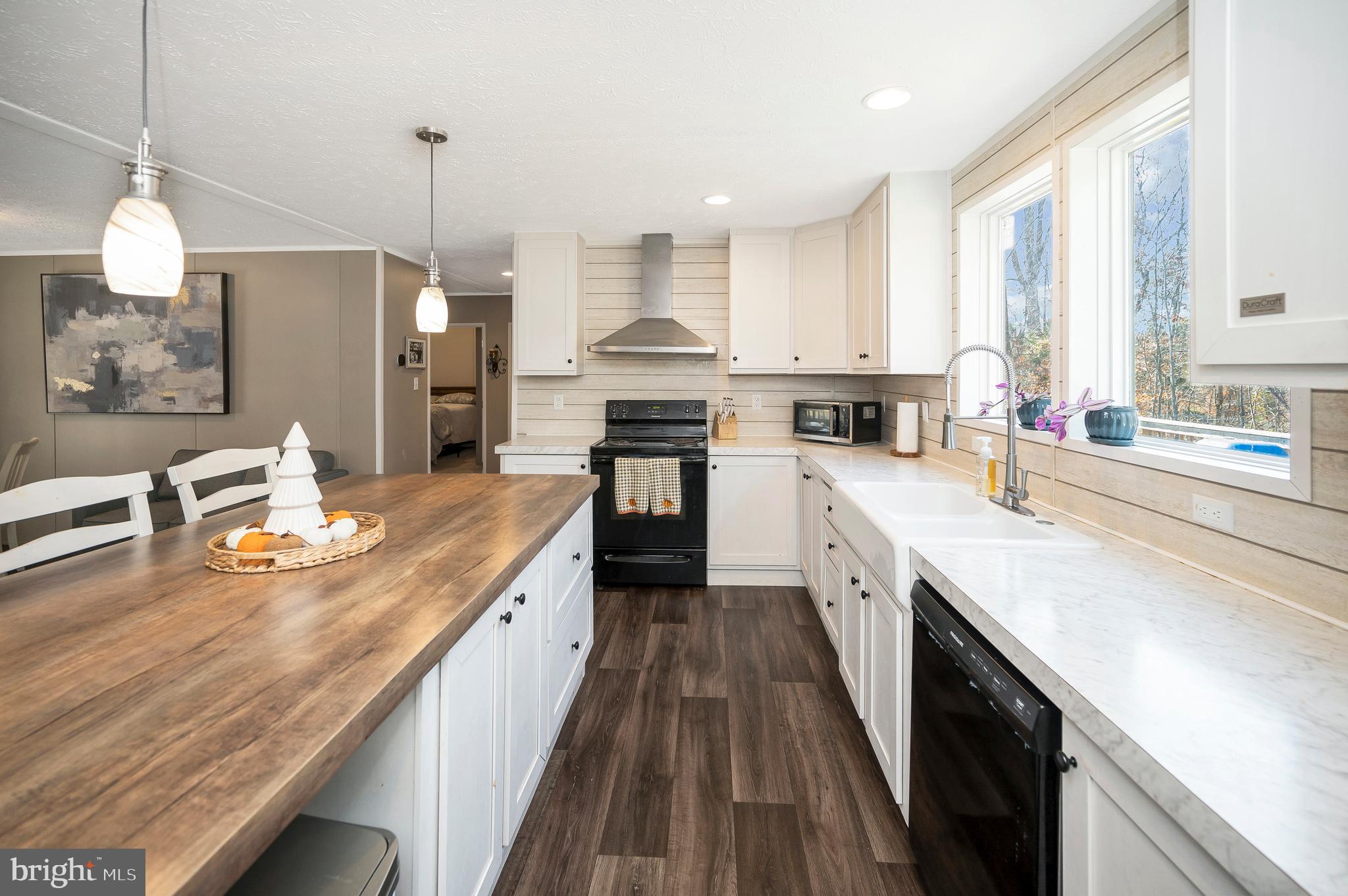 5120 Burr Hill Road Rhoadesville, VA 22542 - Photo 13 of 45 a large kitchen with stainless steel appliances granite countertop a stove a sink and a wooden floors