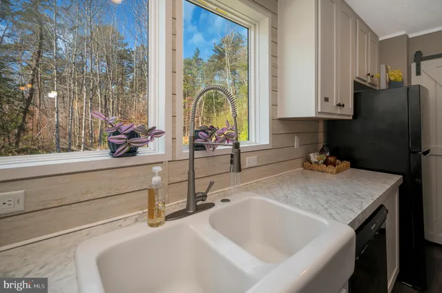 a kitchen with a sink and a large window