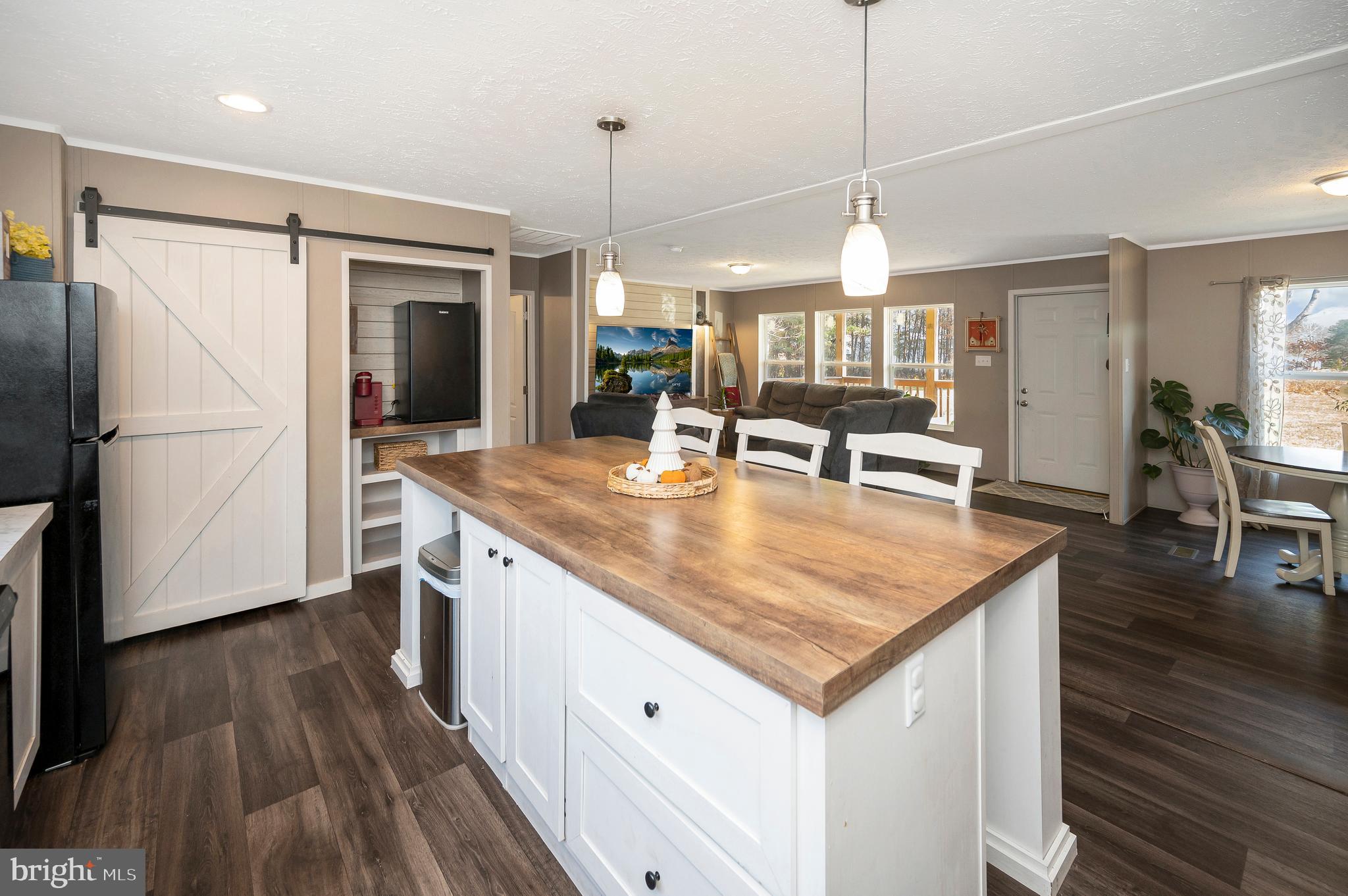 5120 Burr Hill Road Rhoadesville, VA 22542 - Photo 18 of 45 a kitchen with stainless steel appliances granite countertop a sink a stove a refrigerator and island with wooden floor