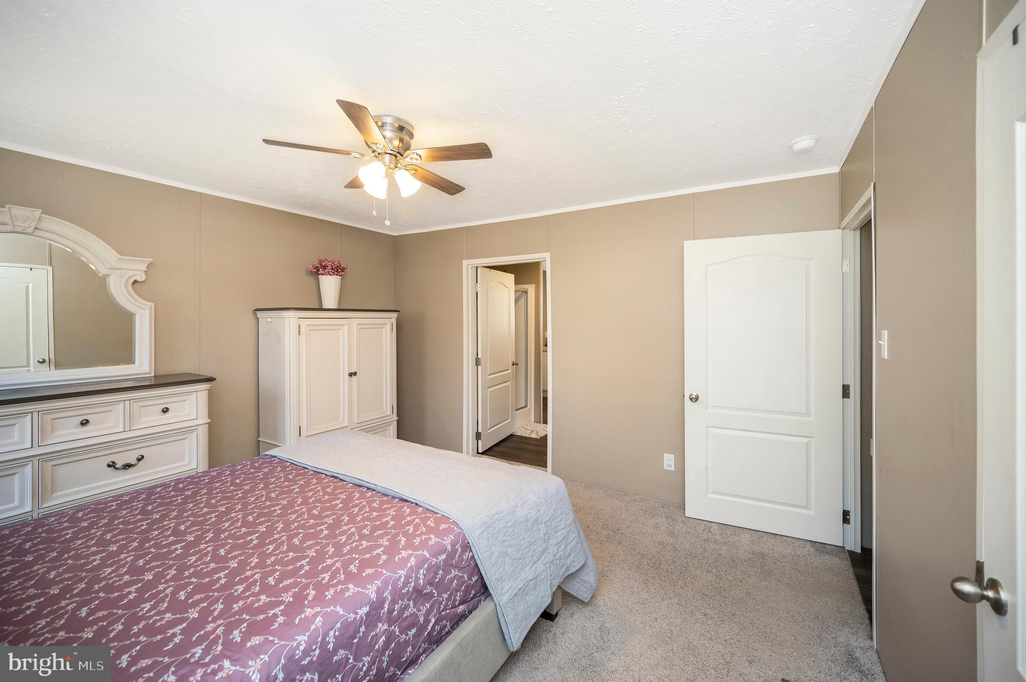 5120 Burr Hill Road Rhoadesville, VA 22542 - Photo 22 of 45 a bedroom with a bed and a dresser