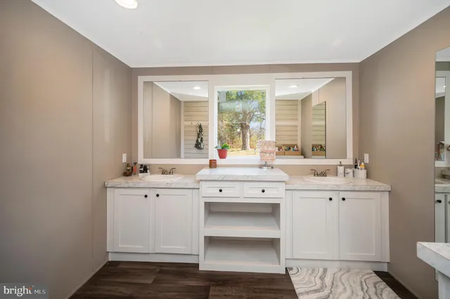 a bathroom with a sink mirror and a toilet