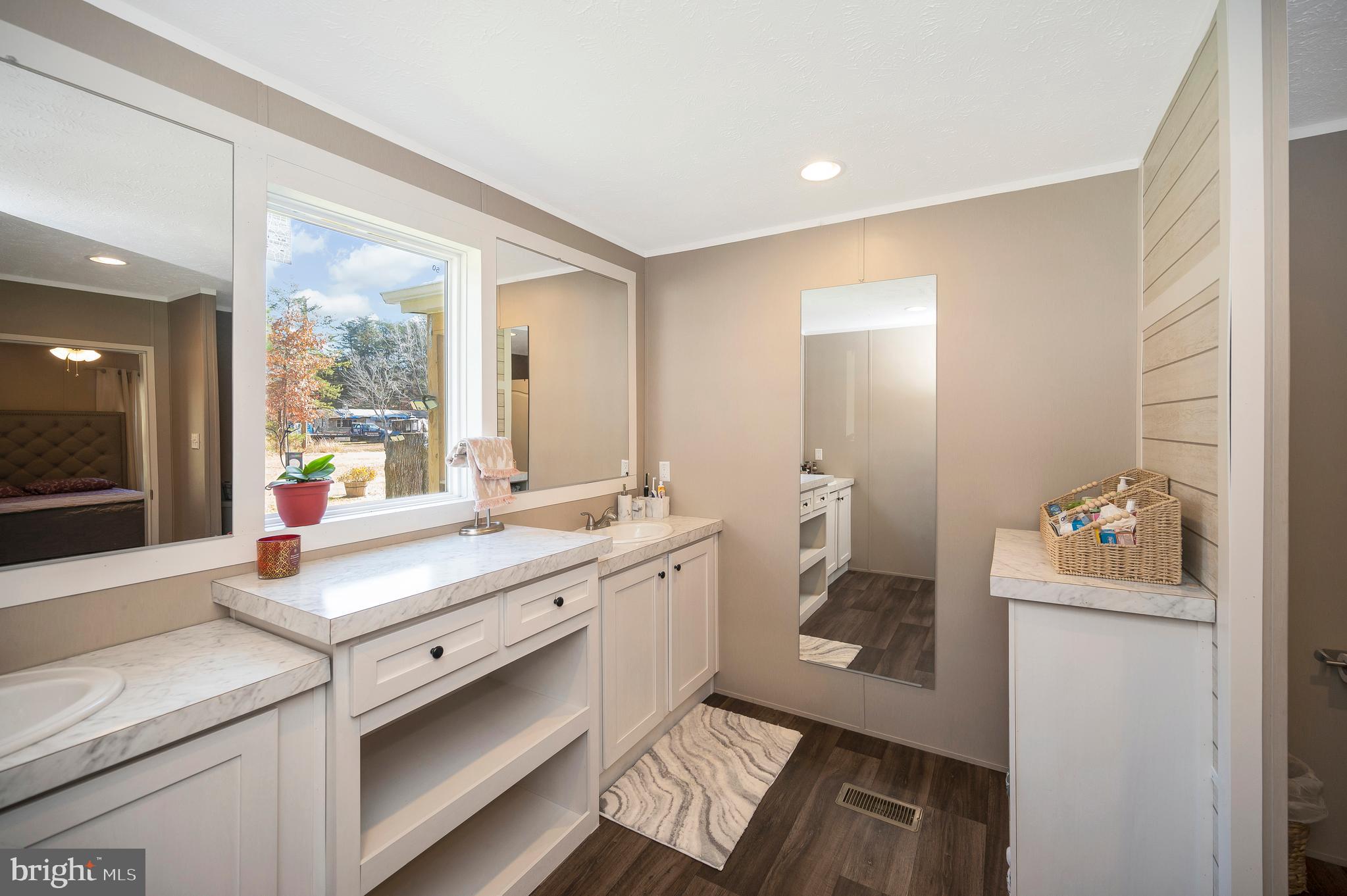 5120 Burr Hill Road Rhoadesville, VA 22542 - Photo 24 of 45 a bathroom with a sink mirror and a toilet