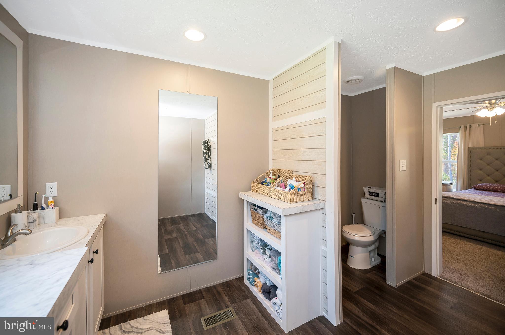 5120 Burr Hill Road Rhoadesville, VA 22542 - Photo 25 of 45 a en suite bathroom with a granite countertop sink and a mirror