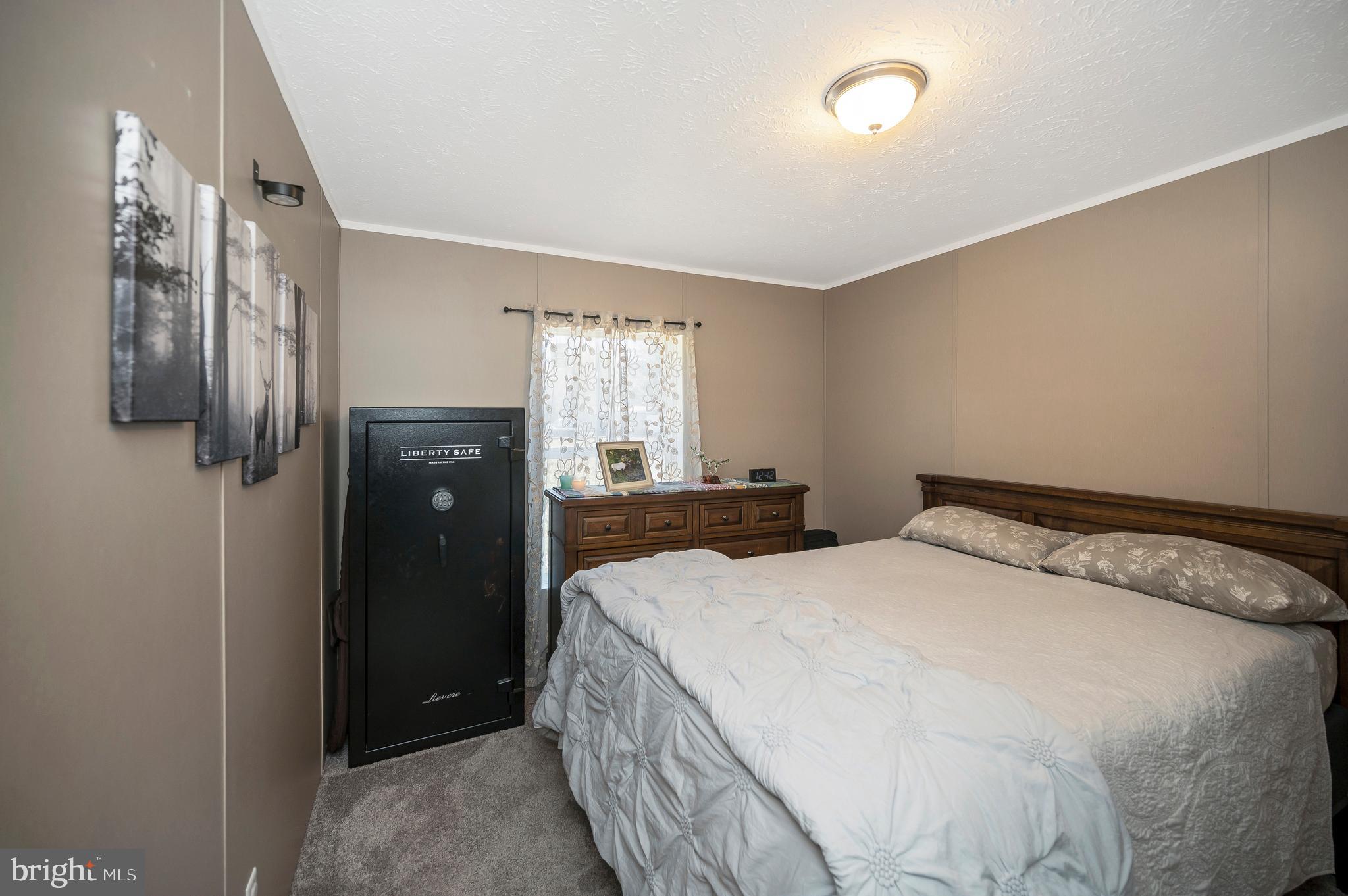 5120 Burr Hill Road Rhoadesville, VA 22542 - Photo 26 of 45 a bedroom with a bed and a view of bathroom