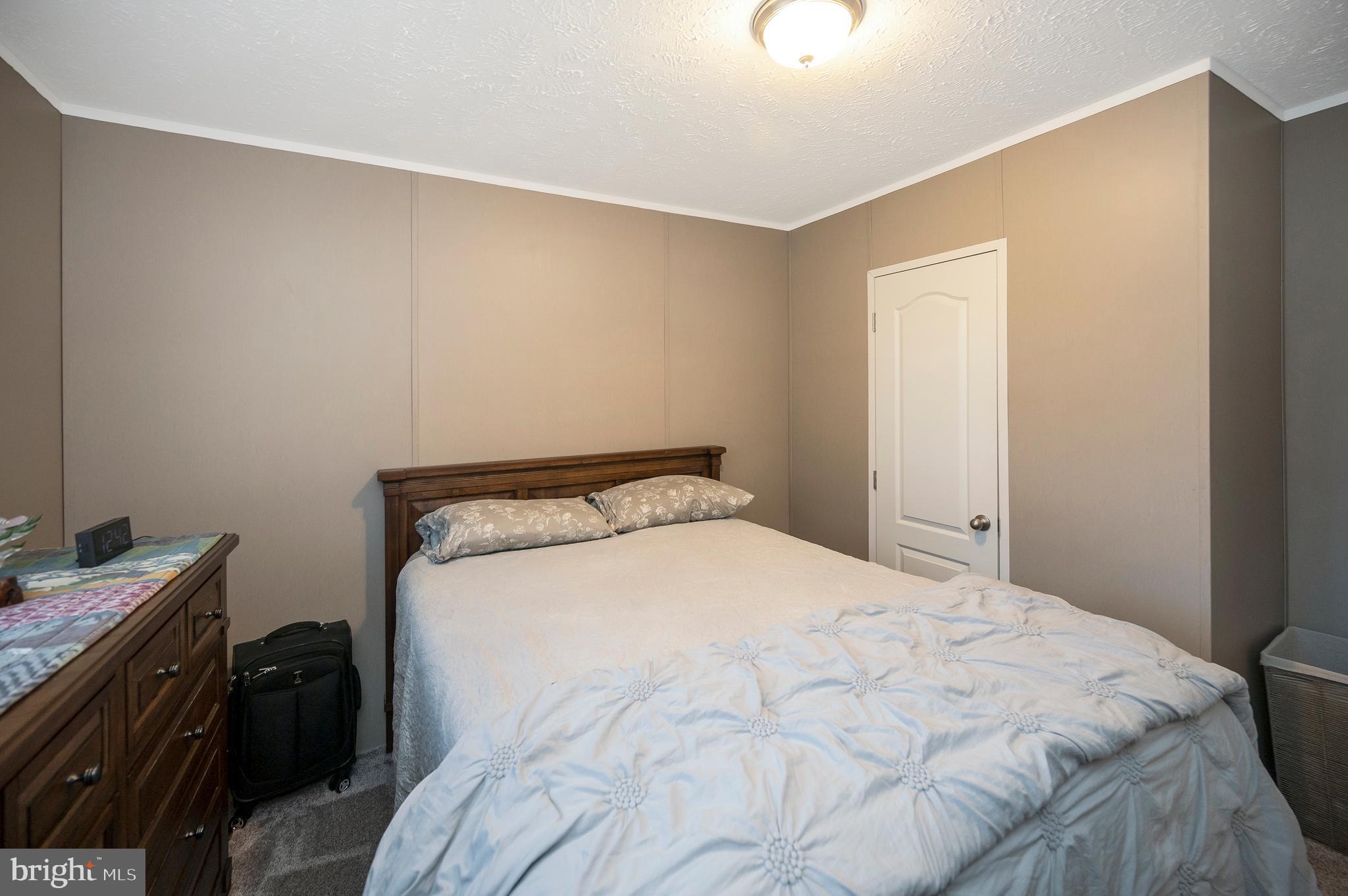 5120 Burr Hill Road Rhoadesville, VA 22542 - Photo 27 of 45 a large bed sitting in a bedroom next to a window